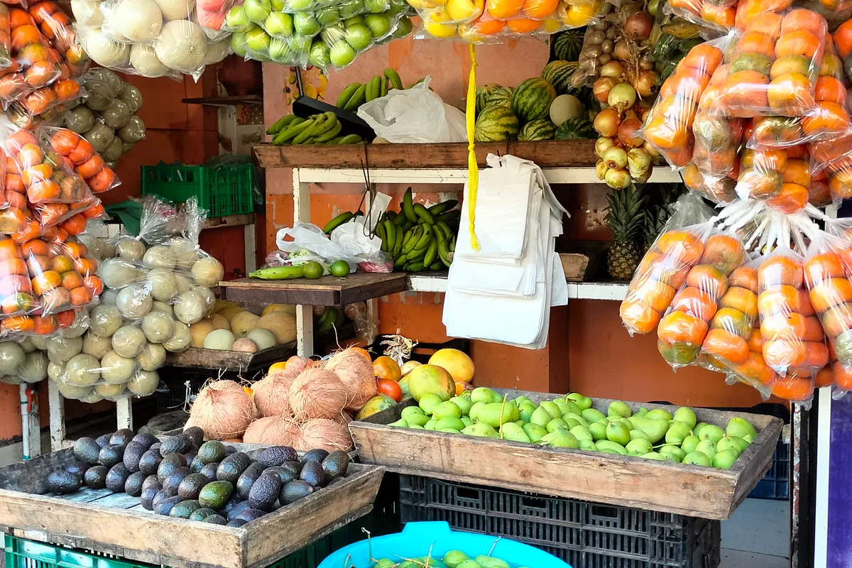 Fruit stand with bananas, pineapples, coconuts and other tropical fruit